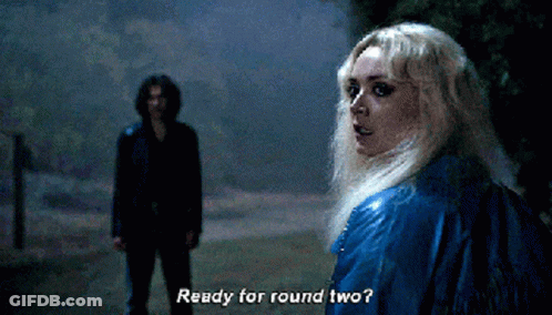 A Woman In A Blue Jacket Says " Ready For Round Two " In Front Of A Man In A Black Jacket GIF