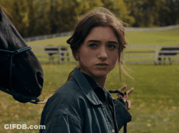 A Woman In A Blue Jacket Stands Next To A Horse GIF