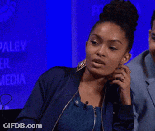A Woman In A Blue Jacket Talks On A Phone GIF