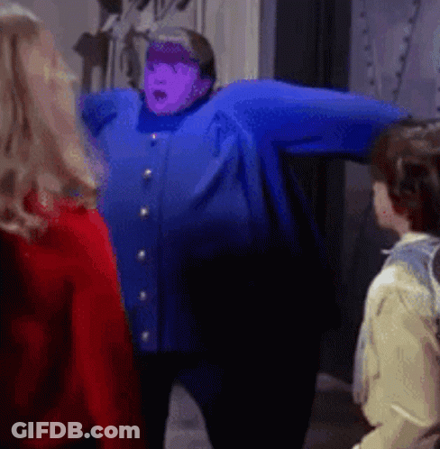 A Woman In A Blue Jacket With A Purple Face GIF