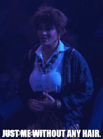 A Woman In A Blue Jacket With The Words Just Me Without Any Hair GIF