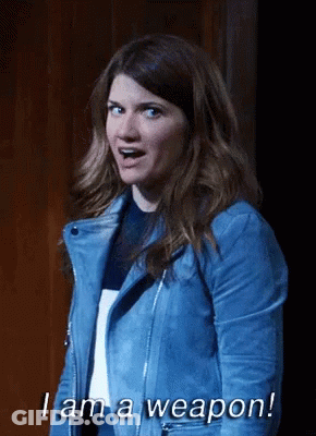 A Woman In A Blue Leather Jacket Says I Am A Weapon GIF