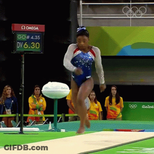 A Woman In A Blue Leotard Jumps On A Balance Beam In Front Of A Omega Sign GIF
