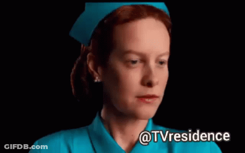 A Woman In A Blue Nurse 'S Uniform Is Making A Funny Face . GIF