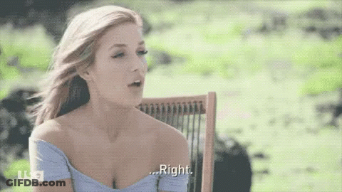 A Woman In A Blue Off The Shoulder Top Is Sitting In A Chair And Says Right GIF