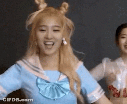 A Woman In A Blue Sailor Outfit Is Dancing With Another Woman . GIF