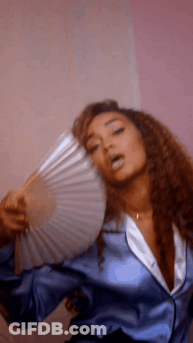 Woman In Blue Satin Jacket Holding Fan GIF