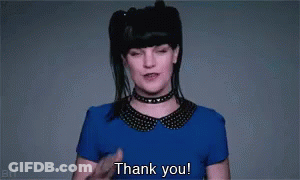 A Woman In A Blue Shirt And Choker Is Saying Thank You . GIF