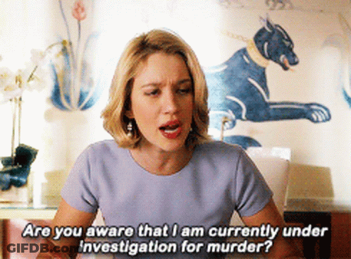 A Woman In A Blue Shirt Is Asking If She Is Currently Under Investigation For Murder GIF