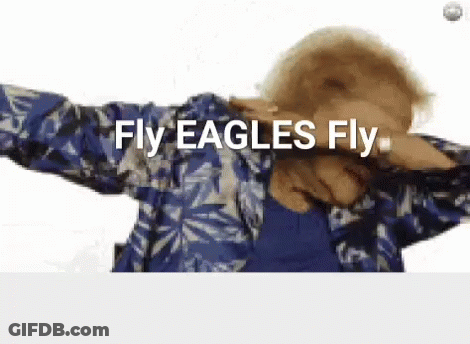 A Woman In A Blue Shirt Is Dancing And Says Fly Eagles Fly GIF