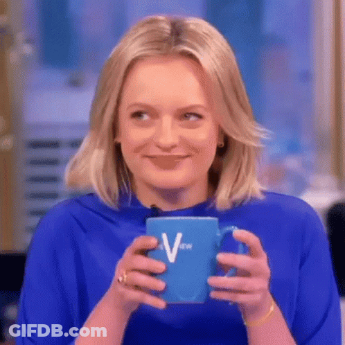 A Woman In A Blue Shirt Is Holding A Blue Cup Of Coffee . GIF