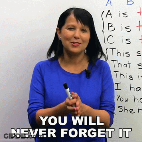 A Woman In A Blue Shirt Is Holding A Marker In Front Of A White Board That Says You Will Never Forget It GIF