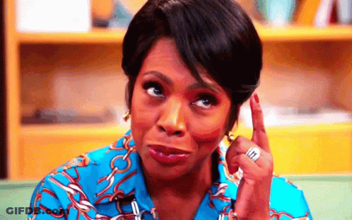A Woman In A Blue Shirt Is Making A Funny Face While Pointing Up . GIF