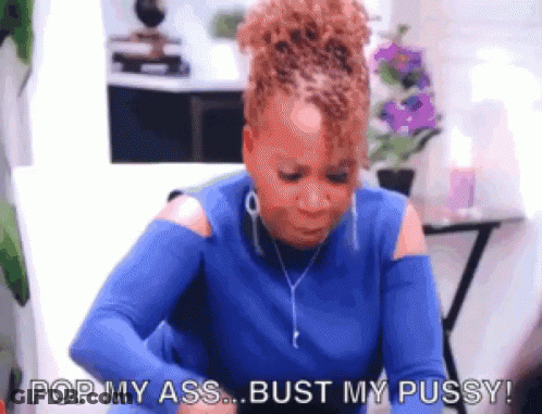 A Woman In A Blue Shirt Is Sitting At A Table And Says Pop My Ass Bust My Pussy . GIF