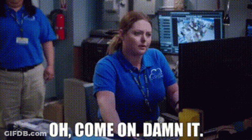 A Woman In A Blue Shirt Is Sitting In Front Of A Computer And Says `` Oh , Come On , Damn It . '' GIF