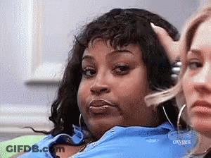 A Woman In A Blue Shirt Is Sitting Next To Another Woman Who Is Making A Funny Face . GIF