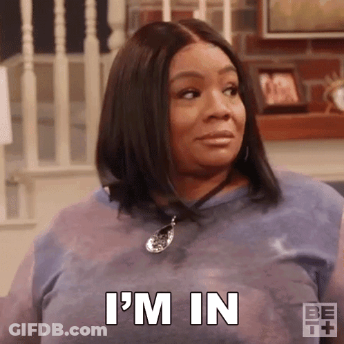 A Woman In A Blue Shirt Is Sitting On A Couch And Says `` I 'M In '' . GIF