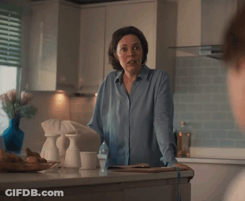 A Woman In A Blue Shirt Is Standing In A Kitchen With The Words " Uh ... Not Following " Below Her GIF