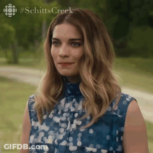 Woman In Blue Shirt Standing In Park GIF
