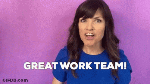 A Woman In A Blue Shirt Is Standing In Front Of A Purple Background And Saying `` Great Work Team '' . GIF