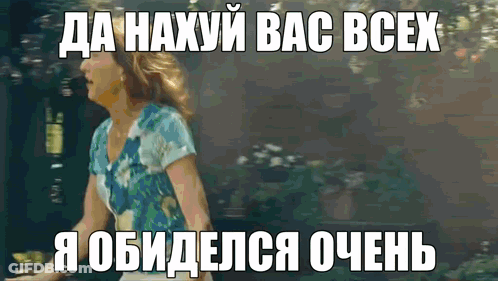 A Woman In A Blue Shirt Is Standing In Front Of A Sign That Says " Da Haxyu Bac Bcex " GIF