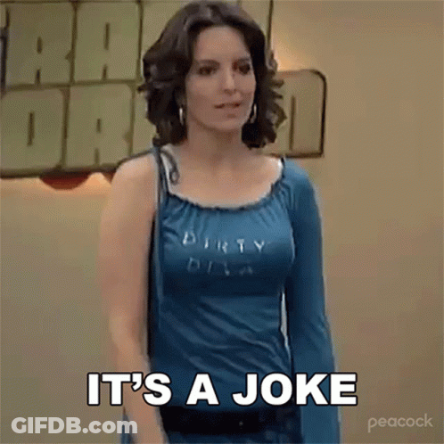 A Woman In A Blue Shirt Is Standing In Front Of A Sign That Says It 'S A Joke . GIF