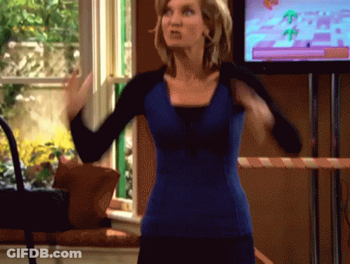 A Woman In A Blue Shirt Is Standing In Front Of A Television Screen GIF