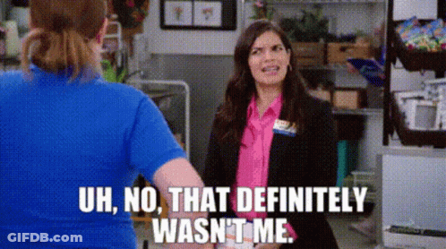 A Woman In A Blue Shirt Is Standing Next To A Woman In A Pink Shirt . GIF