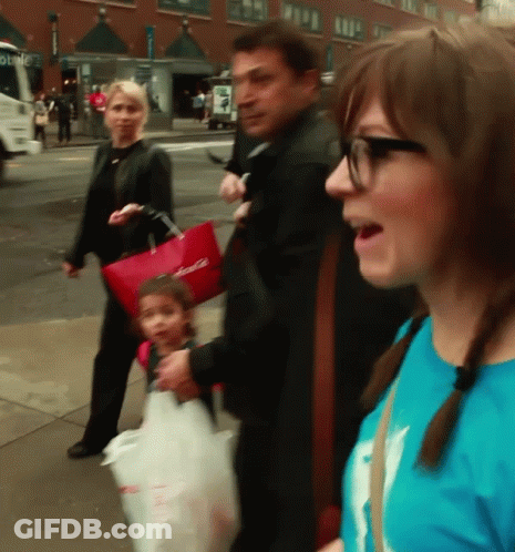 A Woman In A Blue Shirt Is Talking To A Man And Child GIF