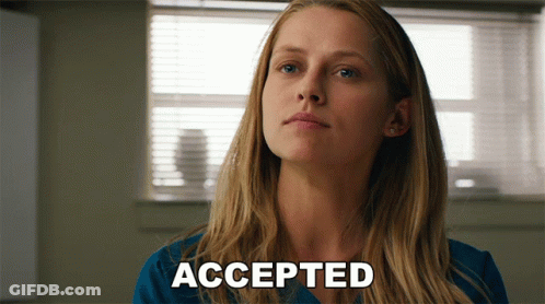 A Woman In A Blue Shirt Says Accepted In Front Of A Window GIF