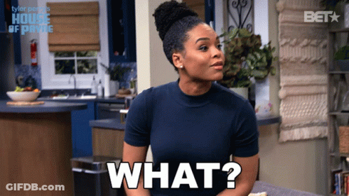 A Woman In A Blue Shirt Says What In A Kitchen GIF
