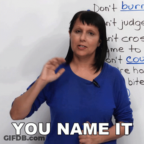 A Woman In A Blue Shirt Stands In Front Of A White Board That Says You Name It GIF