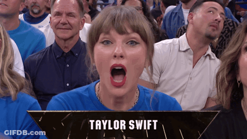 A Woman In A Blue Shirt With The Name Taylor Swift On The Bottom Right GIF