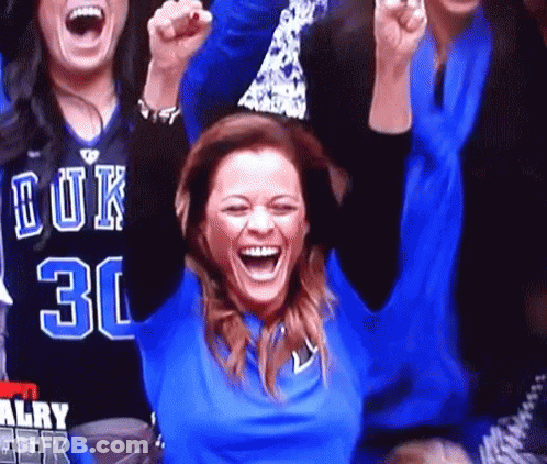 A Woman In A Blue Shirt With The Number 30 On It Is Laughing GIF