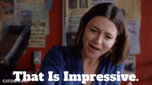 A Woman In A Blue Shirt With The Words That Is Impressive GIF