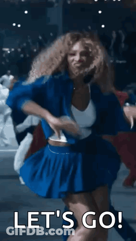 A Woman In A Blue Skirt Is Dancing With The Words `` Let 'S Go '' Behind Her . GIF