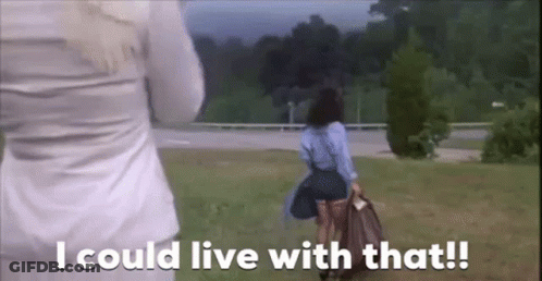 A Woman In A Blue Skirt Is Walking In A Field With The Words `` I Could Live With That '' . GIF