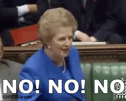 A Woman In A Blue Suit Is Sitting In A Parliament And Says " No " GIF