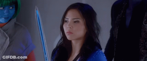 A Woman In A Blue Suit Is Sitting In Front Of A Group Of People And Says Fight . GIF