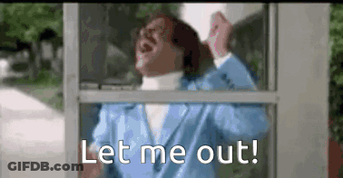 A Woman In A Blue Suit Is Standing In A Pay Phone Booth And Talking On A Cell Phone . GIF