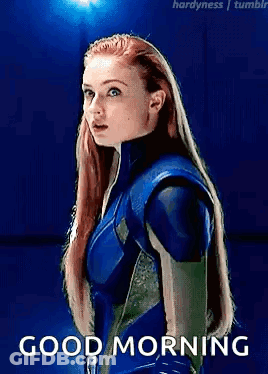 A Woman In A Blue Suit Is Standing In Front Of A Blue Background With The Words `` Good Morning '' . GIF