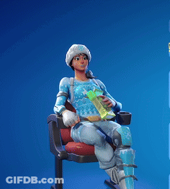 A Woman In A Blue Sweater Is Sitting On A Chair Holding A Book In Her Hand GIF