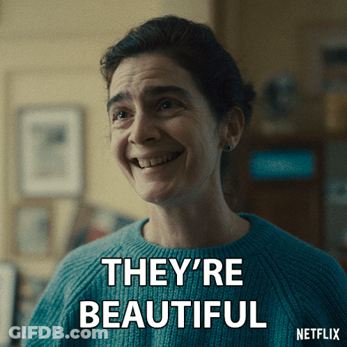 A Woman In A Blue Sweater Is Smiling With The Words They 'Re Beautiful Below Her GIF
