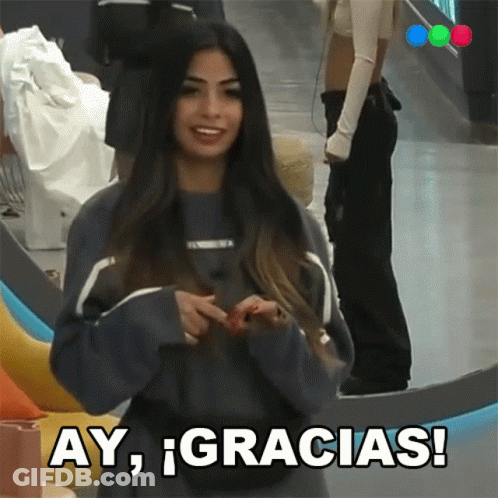 A Woman In A Blue Sweater Says Ay Gracias In Spanish GIF