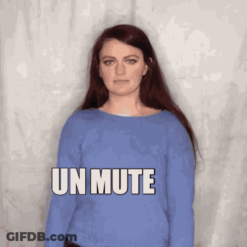 A Woman In A Blue Sweater Says Un Mute In White Letters GIF