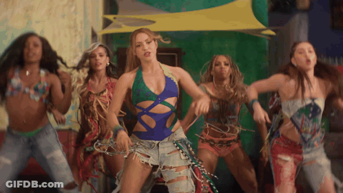 A Woman In A Blue Swimsuit Is Surrounded By Other Women GIF