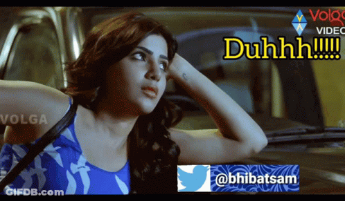 A Woman In A Blue Tank Top Is Sitting In A Car With The Words Duhhhh Written On The Bottom GIF