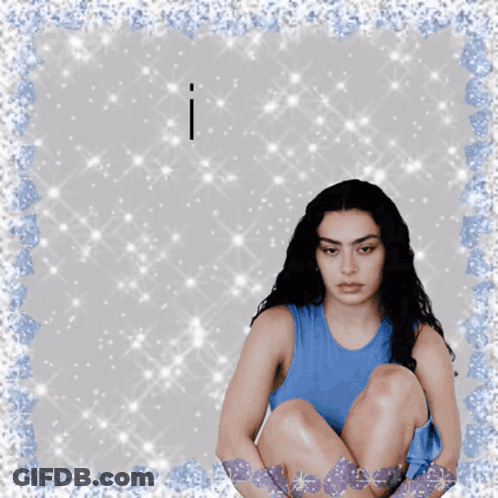 A Woman In A Blue Tank Top Sits On The Floor With The Words I Have Above Her GIF