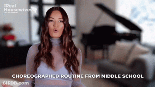 A Woman In A Blue Top Is Talking About Her Choreographed Routine From Middle School GIF