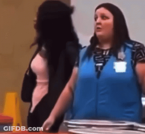 A Woman In A Blue Vest Is Standing Next To A Woman In A Pink Dress . GIF